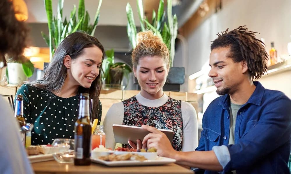 Customers using a tablet to order at a table